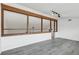 Bonus room with wood beam details and grey flooring at 7904 Dunstable Cir, Orlando, FL 32817