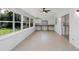 Sunroom with tile floors, built-in workspace and backyard access at 7904 Dunstable Cir, Orlando, FL 32817