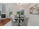 Bright dining room features a glass table and four chairs, with access to the screened porch at 812 Shell Ln, Longwood, FL 32750