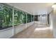 Relaxing screened porch with tiled floors and view of trees at 812 Shell Ln, Longwood, FL 32750