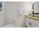 Simple half bathroom with granite countertop and white cabinetry at 812 Shell Ln, Longwood, FL 32750