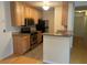 Kitchen features wood cabinets, stainless steel appliances, and a breakfast bar at 6088 Westgate Dr # 203, Orlando, FL 32835