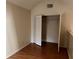 Bedroom with wood flooring and a double-door closet at 6088 Westgate Dr # 203, Orlando, FL 32835