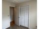 Bedroom with double door closet and carpet flooring at 6088 Westgate Dr # 203, Orlando, FL 32835