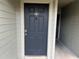 Condo building entry with dark door and light walls at 6088 Westgate Dr # 203, Orlando, FL 32835