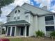 Two-story condo building with green exterior and balconies at 6088 Westgate Dr # 203, Orlando, FL 32835