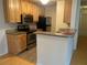 Kitchen features wood cabinets, stainless steel appliances, and a breakfast bar at 6088 Westgate Dr # 203, Orlando, FL 32835