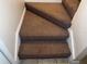 Brown carpeted stairs leading to the upper level at 6088 Westgate Dr # 203, Orlando, FL 32835