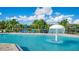 Refreshing community pool with mushroom fountain and lounge chairs at 4976 Town N Ter, Kissimmee, FL 34758