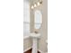 Small bathroom with pedestal sink and oval mirror at 655 Pensacola Ln, Lake Mary, FL 32746