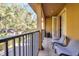 Private balcony with treetop views and seating for two at 655 Pensacola Ln, Lake Mary, FL 32746