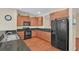 Modern kitchen with wood cabinets, granite countertops and black appliances at 655 Pensacola Ln, Lake Mary, FL 32746