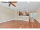Open living room with hardwood floors, kitchen view, and access to balcony at 655 Pensacola Ln, Lake Mary, FL 32746