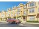 Front view of yellow townhouses with parking at 655 Pensacola Ln, Lake Mary, FL 32746