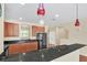 Modern kitchen with wood cabinets, granite counters and black appliances at 655 Pensacola Ln, Lake Mary, FL 32746