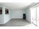 Bright living room with grey vinyl plank flooring and sliding door access to balcony at 301 Lewfield Cir, Winter Park, FL 32792