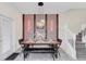 Elegant dining area with a unique wooden table and stylish pendant lighting at 2090 Rome Dr, Kissimmee, FL 34747