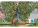 Aerial view showing house, pool, and surrounding trees at 948 Woodcraft Dr, Apopka, FL 32712