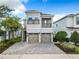 Two-story house with two-car garage and a brick paved driveway at 7702 Graben St, Kissimmee, FL 34747