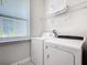Convenient laundry room with washer, dryer, and overhead shelving at 7702 Graben St, Kissimmee, FL 34747