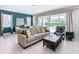 Bright living room with comfy seating, a view of the pool, and access to the outdoors at 7702 Graben St, Kissimmee, FL 34747
