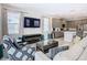 Open concept living room with kitchen views, comfortable seating and large TV at 7702 Graben St, Kissimmee, FL 34747