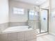 Bathroom with soaking tub and walk-in shower at 7702 Graben St, Kissimmee, FL 34747
