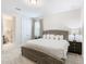 Spacious bedroom with king-size bed, nightstand, and access to a private bathroom at 7702 Graben St, Kissimmee, FL 34747