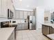 Modern kitchen with stainless steel appliances and gray cabinets at 7702 Graben St, Kissimmee, FL 34747