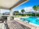 Relaxing backyard oasis with a pool, patio furniture, and a grill at 7702 Graben St, Kissimmee, FL 34747