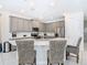 Modern kitchen with gray cabinets, stainless steel appliances, and a breakfast bar at 7702 Graben St, Kissimmee, FL 34747