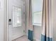 Bright entryway with a stylish glass-paneled door and teal curtains at 7702 Graben St, Kissimmee, FL 34747