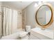 Clean bathroom, featuring an oval mirror and a shower/tub combo at 242 Abbotsbury Dr, Kissimmee, FL 34758