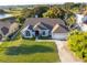 Aerial view of two-story house with driveway and lawn at 7304 High Lake Dr, Orlando, FL 32818