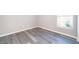 Simple bedroom with gray walls, vinyl plank flooring, and a window at 7304 High Lake Dr, Orlando, FL 32818