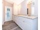 Double vanity bathroom with granite countertop and view to backyard at 7304 High Lake Dr, Orlando, FL 32818