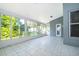 Bright sunroom with tiled floor and view of backyard at 7304 High Lake Dr, Orlando, FL 32818
