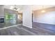 Open living room and dining area with gray walls and vinyl flooring at 7304 High Lake Dr, Orlando, FL 32818