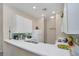 White kitchen with modern appliances and mosaic backsplash at 514 Lucaya Loop # 514, Davenport, FL 33897