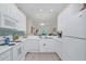 White kitchen with modern appliances and breakfast bar at 514 Lucaya Loop # 514, Davenport, FL 33897