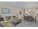 Open living and dining area with light flooring and a view of the kitchen at 514 Lucaya Loop # 514, Davenport, FL 33897