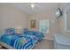 Bedroom with twin beds, ceiling fan, and wicker furniture at 514 Lucaya Loop # 514, Davenport, FL 33897