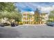 Yellow multi-story building with parking and landscaping at 514 Lucaya Loop # 514, Davenport, FL 33897