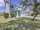 Two-story house with light blue exterior, landscaping, and a paved driveway at 11121 Sunup Ln, Orlando, FL 32825