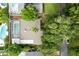 Aerial view showing house, pool, and surrounding trees at 2148 Chippewa Trl, Maitland, FL 32751