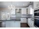 Modern kitchen with white cabinets, granite countertops, and a large island at 2148 Chippewa Trl, Maitland, FL 32751