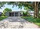 Mid-century modern home with a brick driveway and lush landscaping at 2148 Chippewa Trl, Maitland, FL 32751