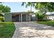 Mid-century modern home with a brick driveway and lush landscaping at 2148 Chippewa Trl, Maitland, FL 32751
