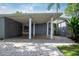 Mid-century modern home with a brick driveway and lush landscaping at 2148 Chippewa Trl, Maitland, FL 32751