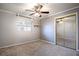Bright bedroom with ceiling fan, mirrored closet, and neutral carpeting at 2148 Chippewa Trl, Maitland, FL 32751
